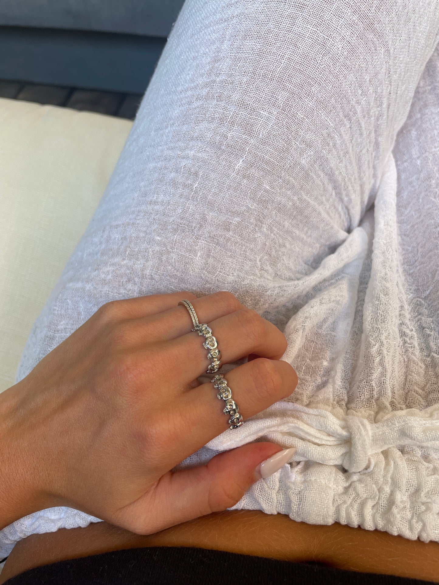 White gold skull eternity rings stacked on hand – J.Tyler Jewelry